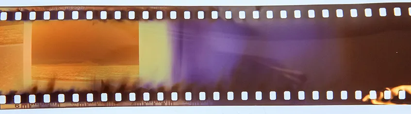 A 35mm negative strip showing an example of light leaks across the film from the camera being opened mid roll