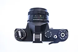 Top view of a black Zenit ET camera showing the main 3 settings - Shutter Speed, Aperture & ISO 